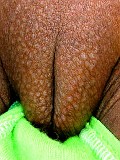 Ebony babe strips and toys close up